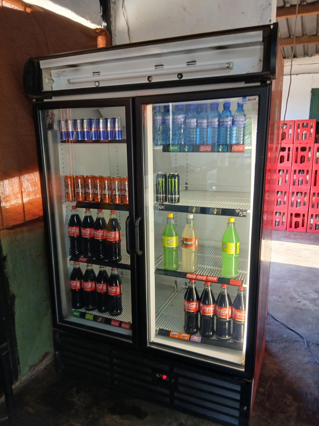 Fully stocked cooldrinks and energy drink refrigerators at Search's Place