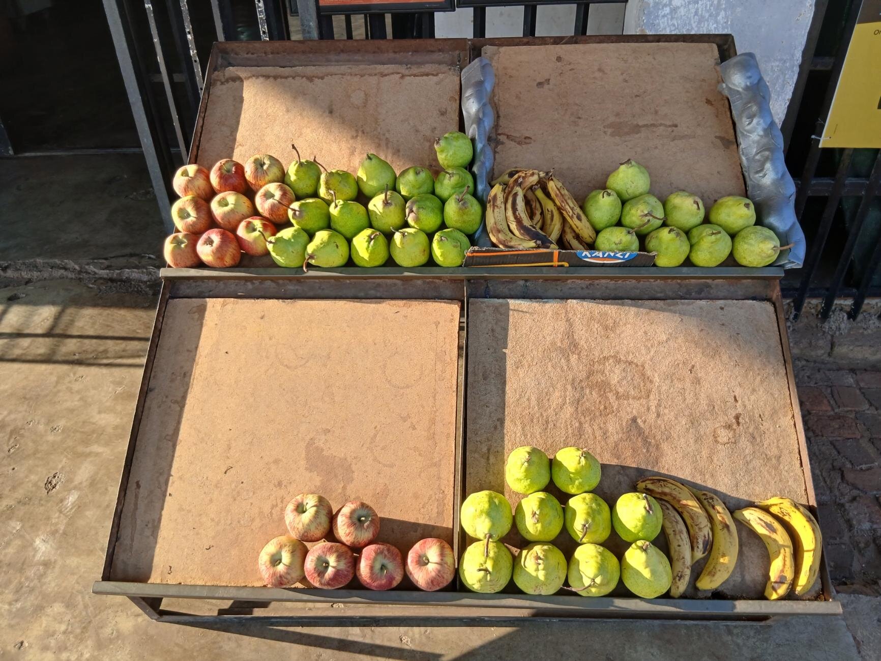 Fresh fruit display with apples, pears, bananas and guavas